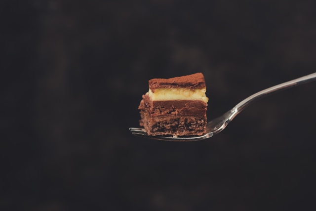 A fork with a bite-sized piece of cake